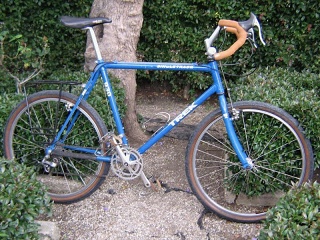 Blue Trek 930, ca. 1993 (1 1/8 inch threaded steerer); US made, lugged True Temper steel. Bought in 2004 or 2005; sold ca. 2017. I dislike anatomic bars; these must been installed in a scraping-the-barrel's-bottom build. 