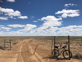 KHS Solo One SE on the eastern Navajo Nation in the spring of 2026. The cow skull is not a purchased adornment; it's from a cow that died on the range you see behind the bike and barbed wire "gate."