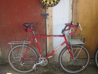Trek 970, early 1990s vintage, here in 2020 or 2021 in utility mode with front and rear racks. Too much red matchy-matchy! 
